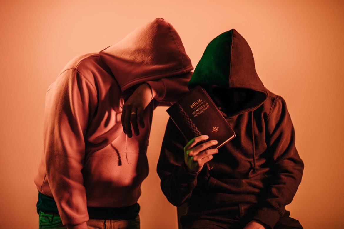 two-person-in-pullover-hoodies-holding-book-1769068.jpg
